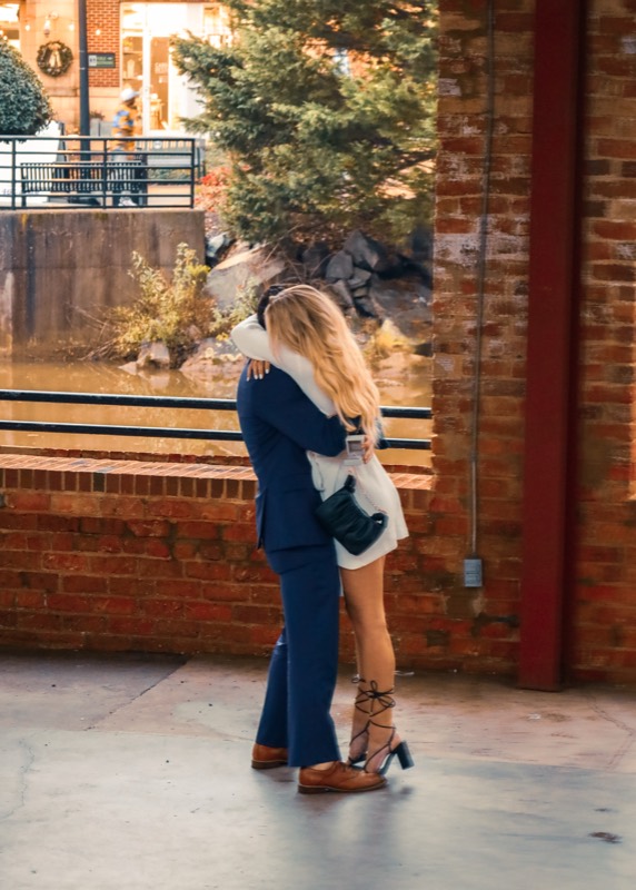 The couple hugging right after she said yes