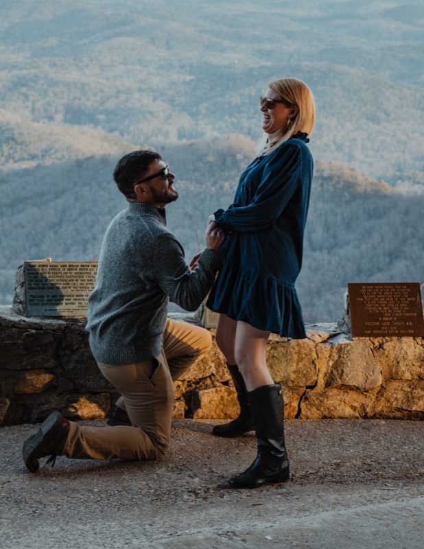Kneeling at the Pretty Place overlook with the Blue Ridge behind them